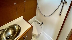 A compact bathroom with a shower, toilet, and sink. - Sun-Kissed Sailing Adventure in Zadar, Croatia (Bibinje)