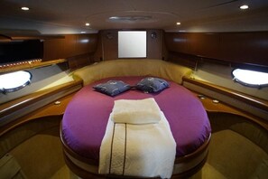 A private cabin with a bed, a television, and a window. - Sun-Kissed Sailing Adventure in Northern Croatia (Punat)
