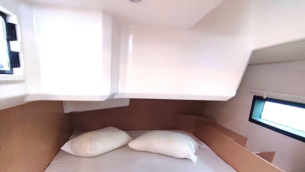 A bunk bed with a small window, white bedding, and rolled towels. - Sun-Kissed Sailing Adventure in the Ionian Islands, Lefkada (Lefkada)