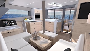 Um interior moderno com cozinha, área de estar e amplas janelas com vista para o mar.