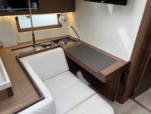 A compact kitchenette with a built-in stove, a small sink, and a countertop. - Sun-Kissed Sailing Adventure in Northern Croatia (Punat)