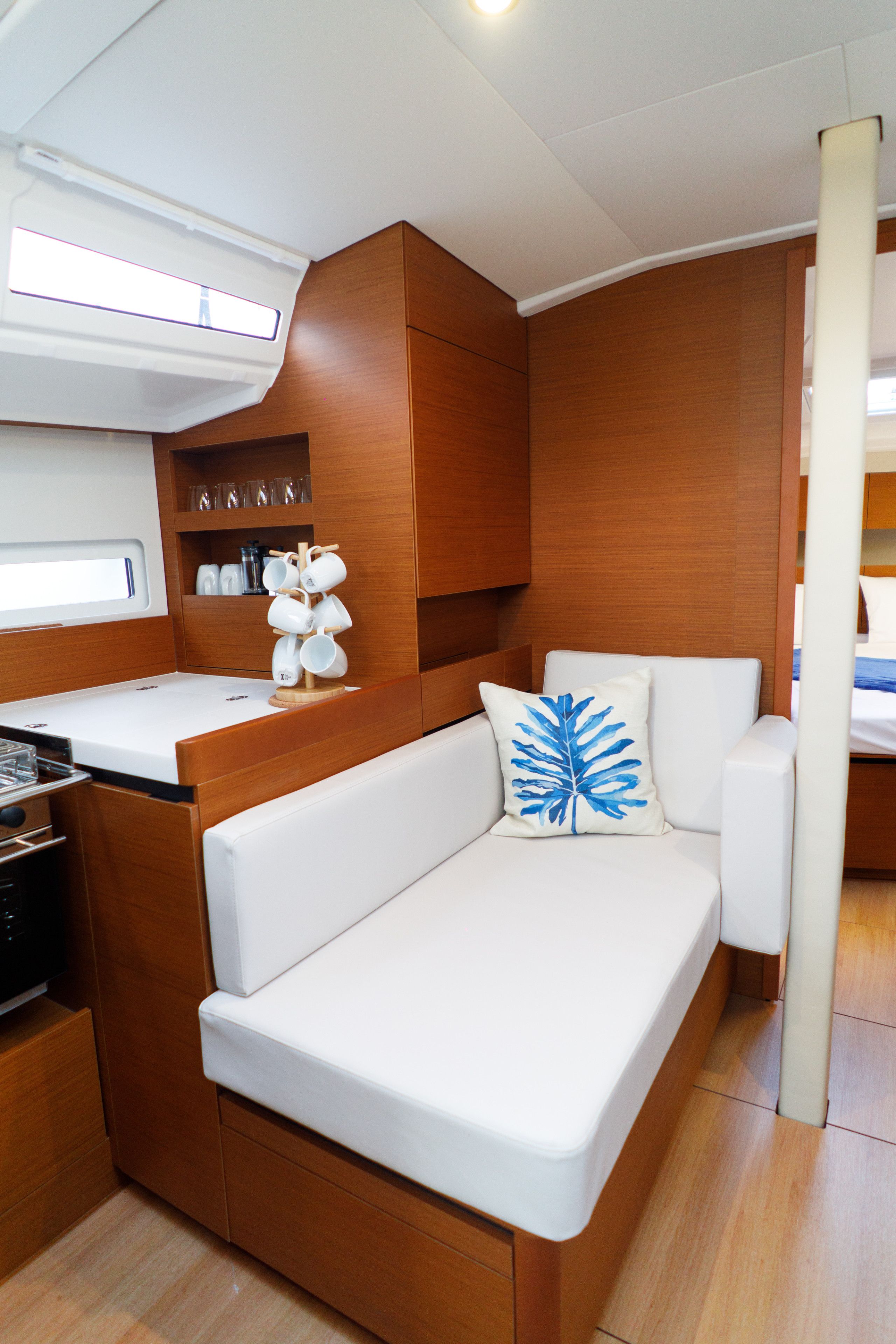 A compact kitchen with a white countertop, wooden cabinets, and a built-in stove.