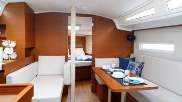 A compact interior with a dining area, seating, and a small kitchenette.
