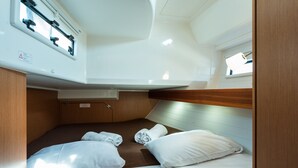 A compact cabin with a bunk bed, a small window, and a control panel above the bed. - Macedonian Sun and Beach Sailing Extravaganza from Kavala (Kavala)