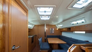 A compact interior with a kitchenette, seating area, and skylights. - Macedonian Sun and Beach Sailing Extravaganza from Kavala (Kavala)