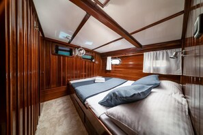 A cabin with a bed, a window, and wooden walls. - Sun-Kissed Sailing Adventure in Split, Croatia (Split)