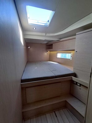 A compact, well-lit interior with a skylight, a small window, and built-in storage. - Sun-Kissed Sailing Adventure in the Ionian Islands, Lefkada (Lefkada)