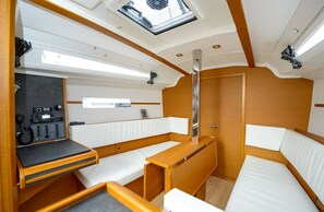 A compact interior with a control panel, a small table, and seating areas. - Sibenik Sun-soaked Sailing: A Luxurious Croatian Voyage (Pirovac)