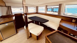 A compact cabin with a dining area, a small kitchenette, and a view of the sea. - Sun-Kissed Sailing Adventure in the Ionian Islands, Lefkada (Lefkada)