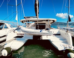 A marina with multiple sailboats docked, featuring a prominent white boat with 'HIGHFIELD' written on the side. - Sun-Kissed Sailing Adventure in the Ionian Islands, Lefkada (Lefkada)