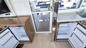 A compact kitchen with built-in appliances, a central ventilation system, and a view of the deck area. - Sun-Kissed Sailing Adventure in Sibenik, Croatia (Primošten)
