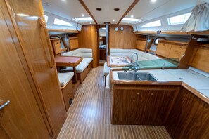 A compact galley with a sink, a small table, and seating.
