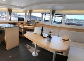 Ein modernes Interieur mit Essbereich, einer kleinen Küche und einer Sitzecke mit Blick.