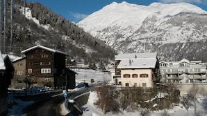 A mountain town with snow-covered buildings, a road, and a mountain in the background. - ABC Ferienwohnung 3 1. OG Nord-Ost Appartement/Fewo, Dusche oder Bad, WC by Interhome (Fiesch)