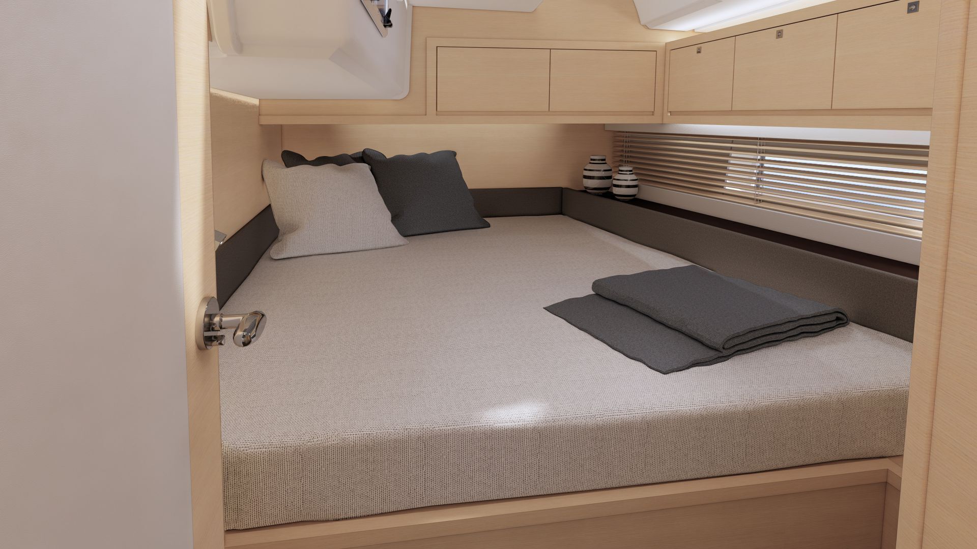 A compact bed with a headboard, pillows, and a folded blanket in a cabin-style room with wooden walls and a window with blinds.