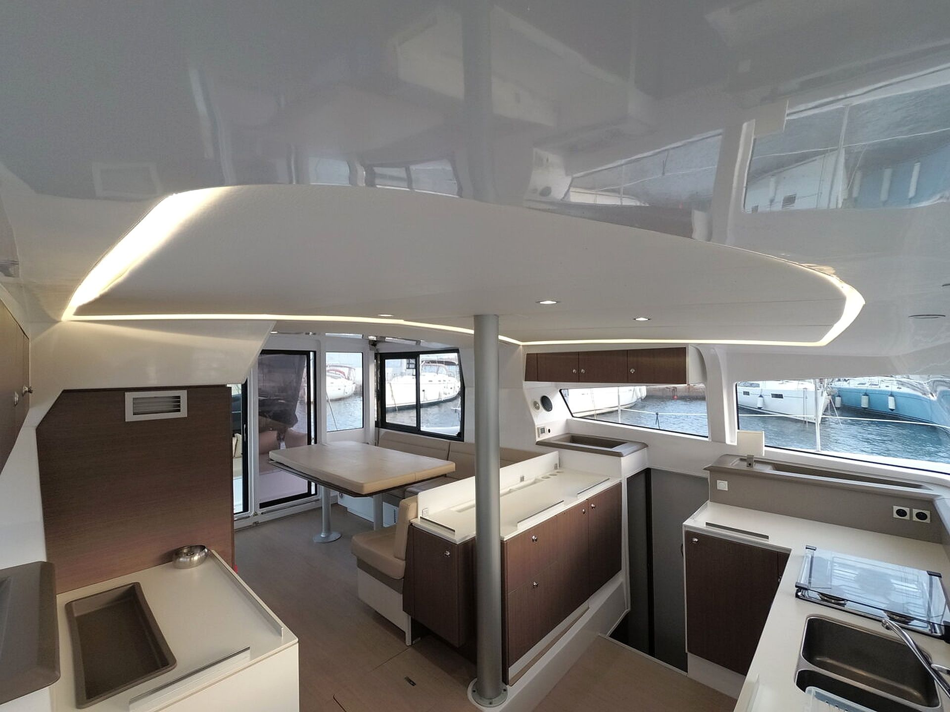A compact galley with a dining area, a sink, and a stove.