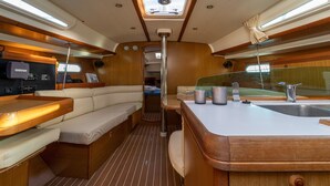A compact galley with a bench seating area, a small sink, and a stove. - Macedonian Sun and Beach Sailing Extravaganza from Kavala (Kavala)
