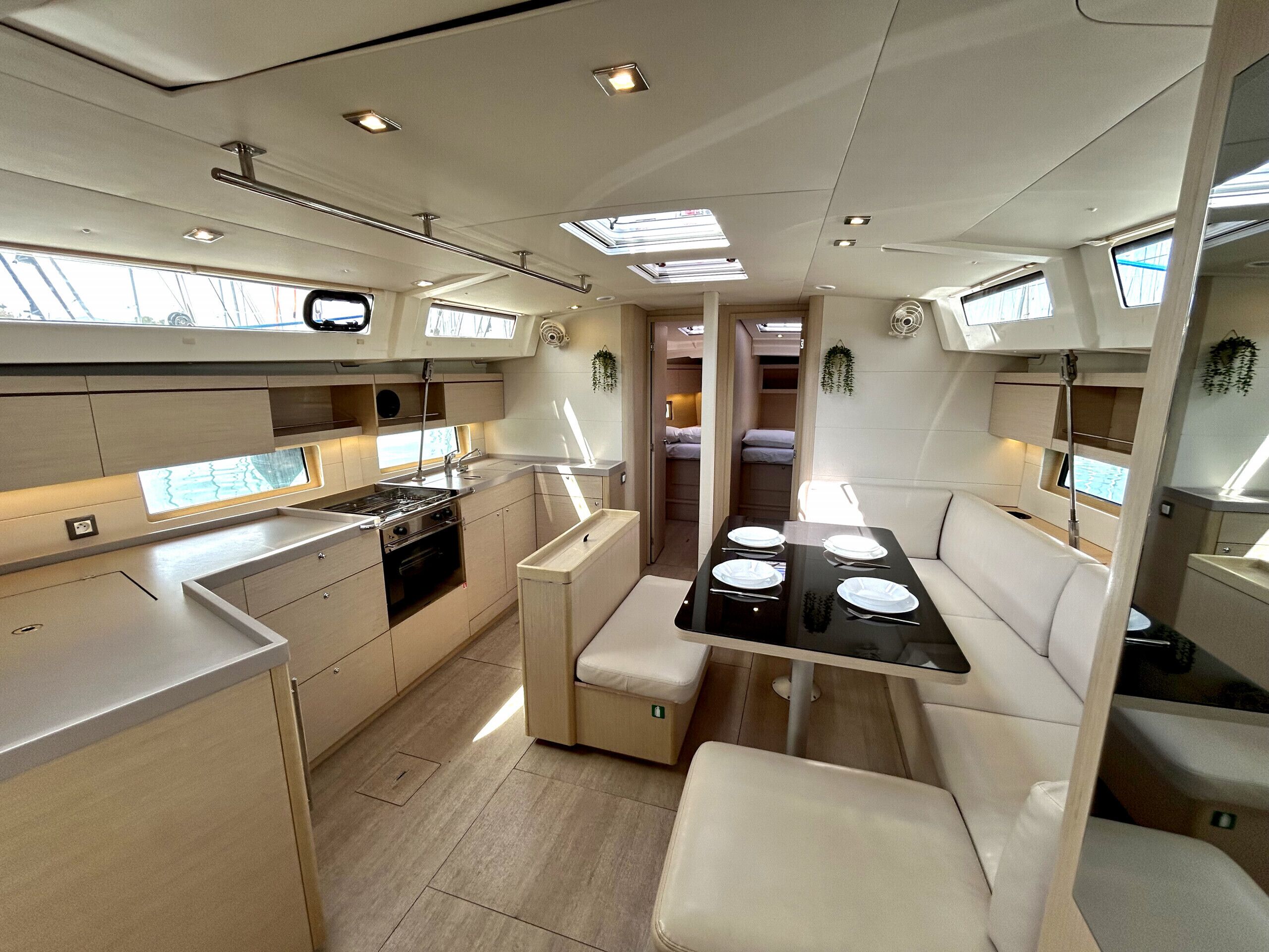 A compact kitchen with a dining area, a stove, and a sink.
