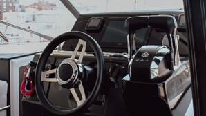 A boat's interior with a steering wheel, dashboard, and a view of the water outside. - Sun-Kissed Sailing Adventure in Zadar, Croatia (Zadar)