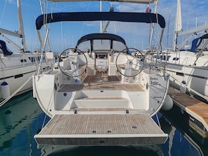 A sailboat docked at a marina with a wooden deck, a steering wheel, and a cabin with 'Fanny' written on it. - Sun-Kissed Sailing Adventure in Zadar, Croatia (Drage)