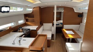 A compact galley with a stove, sink, and wooden cabinets. - Dubrovnik Delight: A Sun-Kissed Sailing Experience (Komolac)