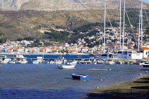 A coastal town with a marina filled with boats, a hillside with buildings, and a clear sky. - Sun-Kissed Sailing Adventure in Split-Dalmacia, Croatia (Podstrana)