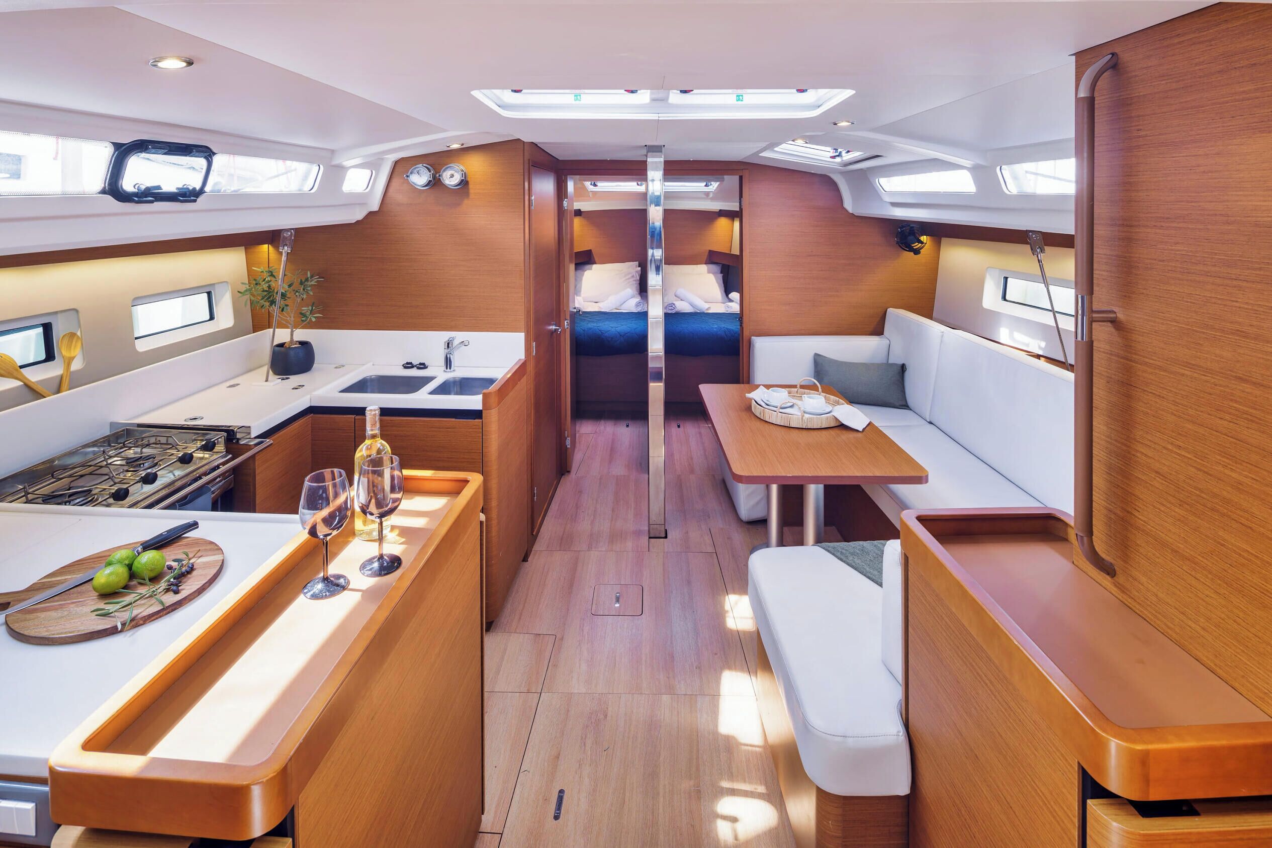 A compact galley with a sink, stove, and seating area.