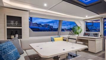 A modern interior with a dining area, seating, and a control panel.