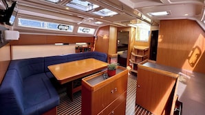 A compact interior with a sofa, a small table, and a kitchenette area. - Sun-Kissed Sailing Adventure in Zadar, Croatia (Bibinje)