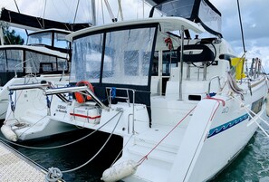 A white yacht with a cabin, deck, and various nautical equipment. - Sun-Kissed Sailing Adventure in Isla de Mahe, Seychelles (Providence)