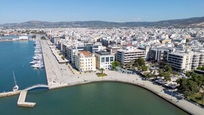 An aerial view of a coastal city with a marina, buildings, and a curved waterfront promenade. - Sun-Kissed Sailing Adventure in the Sporades Islands from Volos, Thessaly (Volos)