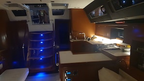 A compact kitchen with a sink, stove, and a small countertop. - Sun-Kissed Sailing Adventure in the Ionian Islands, Lefkada (Lefkada)