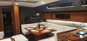 A compact kitchen with a dining area, a small refrigerator, and a microwave.
