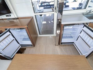 A compact kitchen with built-in appliances, a central ventilation system, and a view of the deck area. - Sun-Kissed Sailing Adventure in Sibenik, Croatia (Primošten)