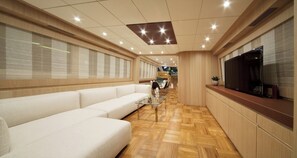 A modern interior with a sofa, a TV, and a dining area. - Sun-Kissed Sailing Adventure in Zadar, Croatia (Drage)