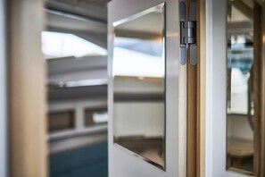 A modern door with a metallic handle and a glass panel.
