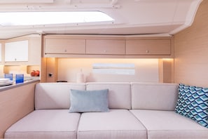 A modern interior with a sofa, a small table, and a window.