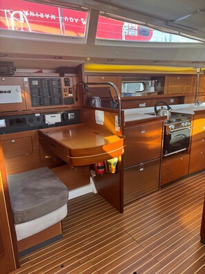A compact galley with a sink, stove, and storage cabinets. - Sun-Kissed Sailing Adventure in Sibenik, Croatia (Rogoznica)