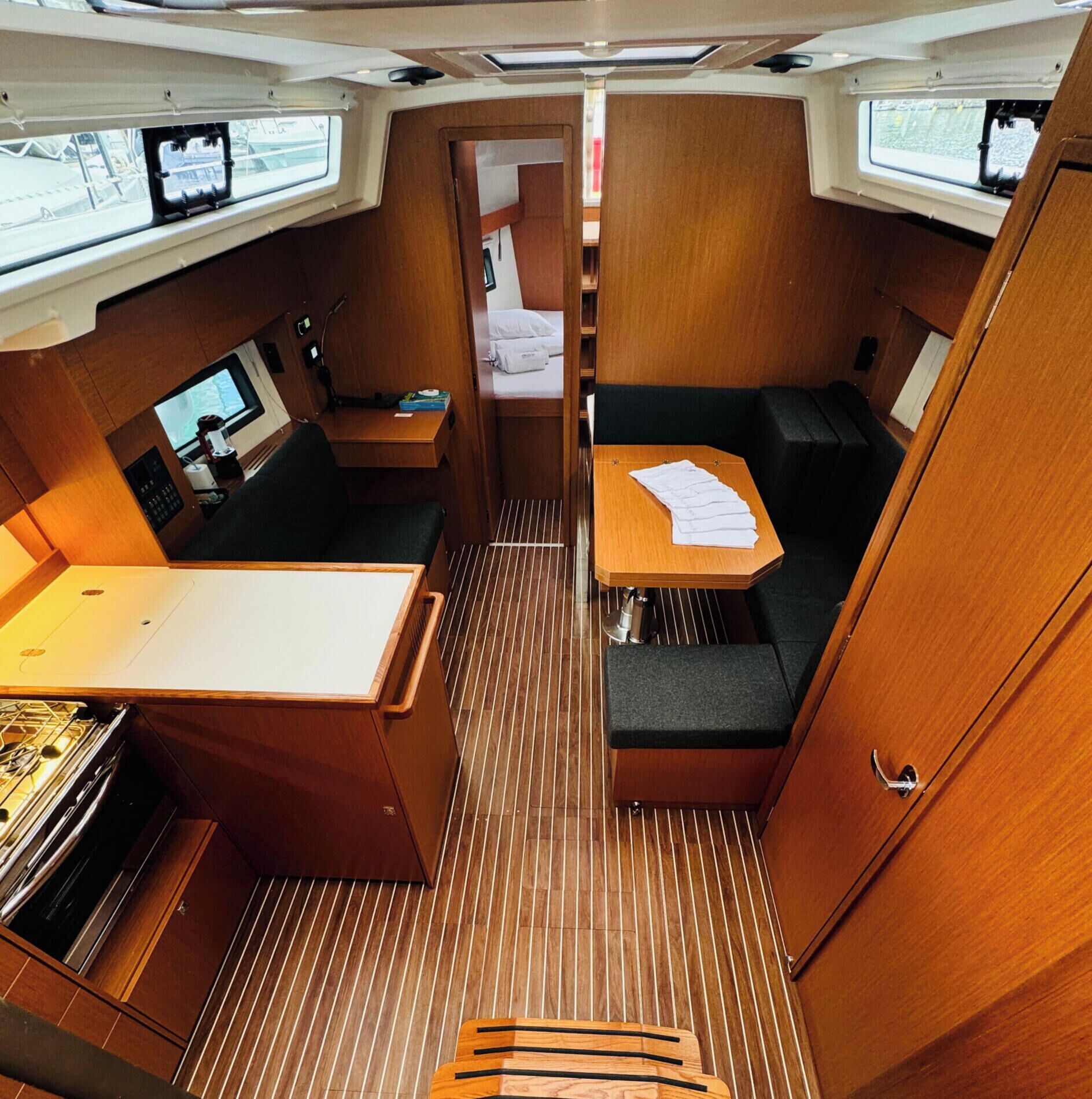 A compact, well-organized interior with a kitchenette, seating area, and a small table with papers.