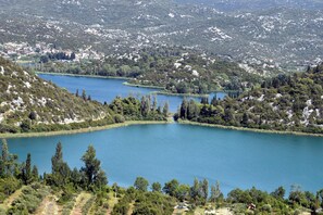 A lake surrounded by hills with scattered buildings.