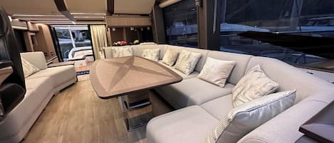 A modern interior with a sofa, a table, and a large window.