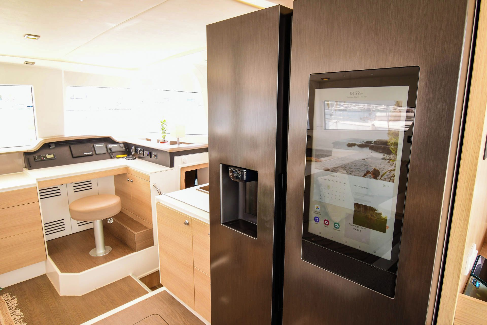 A compact kitchenette with a built-in refrigerator, a sink, and a small countertop.