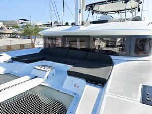A boat's deck with a seating area, a small table, and a ventilation system. - Sun-kissed Sailing Adventure in Split-Dalmatia, Croatia (Seget Donji)