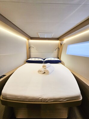 A compact, well-lit room with a single bed, a headboard, and a window. - Sun-kissed Sailing Adventure in Split-Dalmatia, Croatia (Seget Donji)
