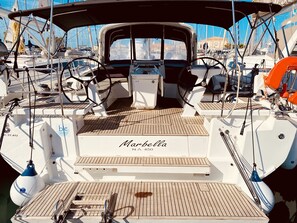 A boat named 'Marbella' with a wooden deck, steering wheel, and various navigational equipment. - Sun-Kissed Sailing Adventure in the Ionian Islands, Lefkada (Lefkada)