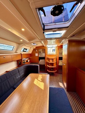 A yacht interior with a dining area, a control panel, and a galley. - Sun-Kissed Sailing Adventure in Zadar, Croatia (Bibinje)