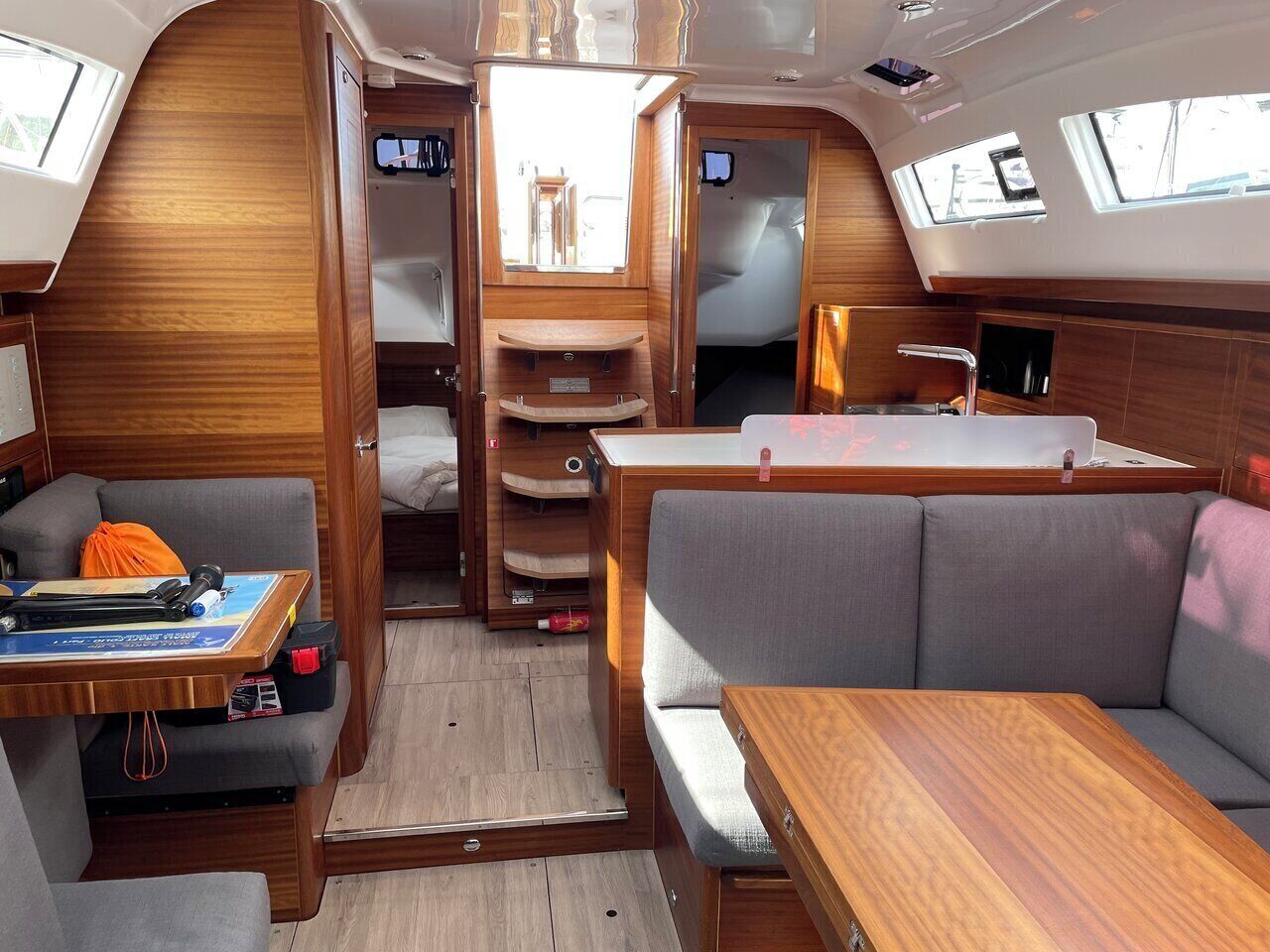 Ein kompaktes Wohnmobil-Interieur mit Essbereich, Sitzgelegenheiten und einer kleinen Küchenzeile.