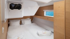 A compact, well-lit room with a bunk bed, a small window with a view, and a control panel above the bed. - Sun-Kissed Sailing Adventure in Zadar, Croatia (Zadar)