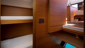 A bunk bed with a control panel, a wooden cabinet, and a small sink area. - Sun-Kissed Sailing Adventure in Sibenik, Croatia (Primošten)
