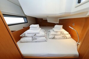 A compact cabin with a bunk bed, a small window, and a shower area. - Sibenik Sun-soaked Sailing: A Luxurious Croatian Voyage (Pirovac)